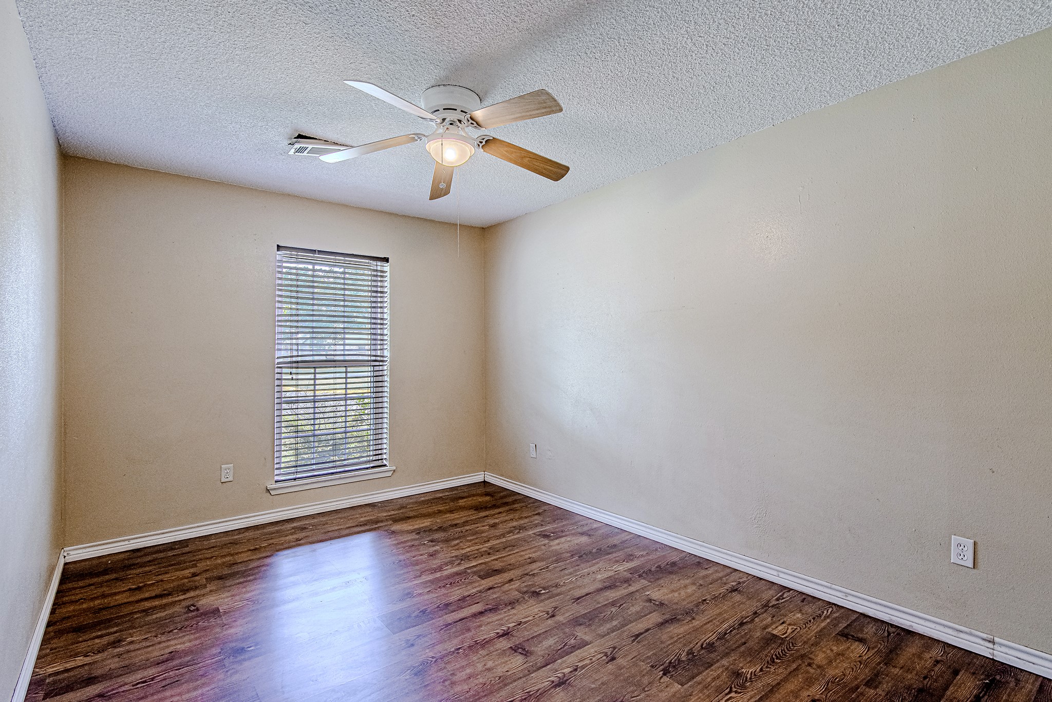 2710 Burke Road Pasadena, TX 77502 - Photo 20 of 28 Comfortable secondary bedroom with wood-look flooring and natural light