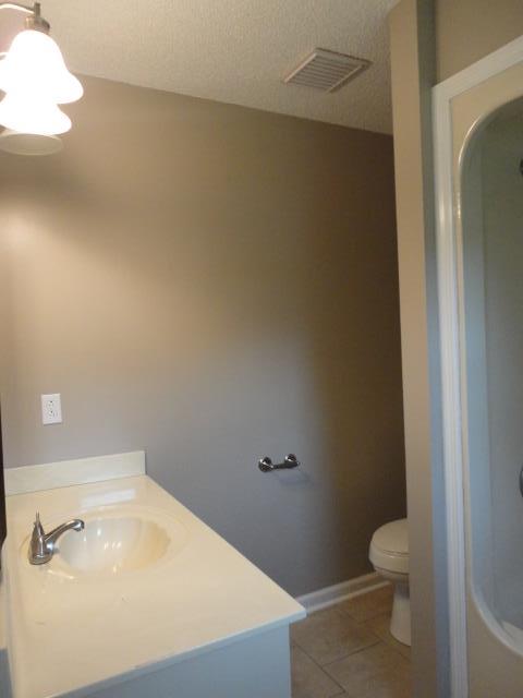 48 Harbin Road Fayetteville, TN 37334 - Photo 12 of 25 a bathroom with a granite countertop toilet and a sink