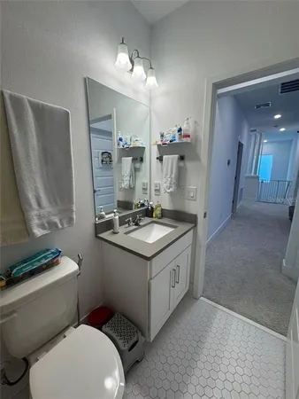 a bathroom with a sink a toilet and mirror