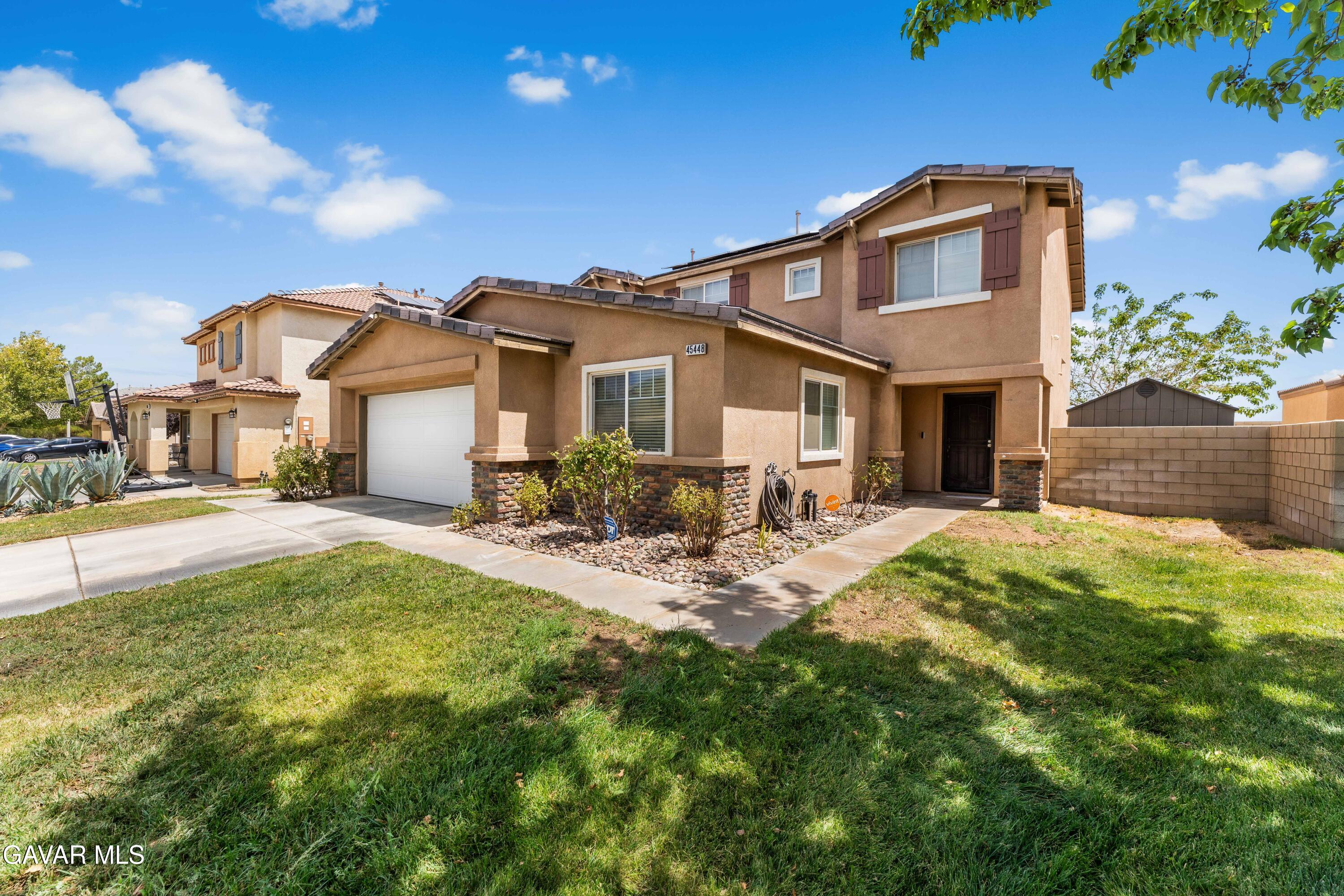 45448 Spahn Lane Lancaster, CA 93535 - Photo 1 of 49 a front view of a house with a yard