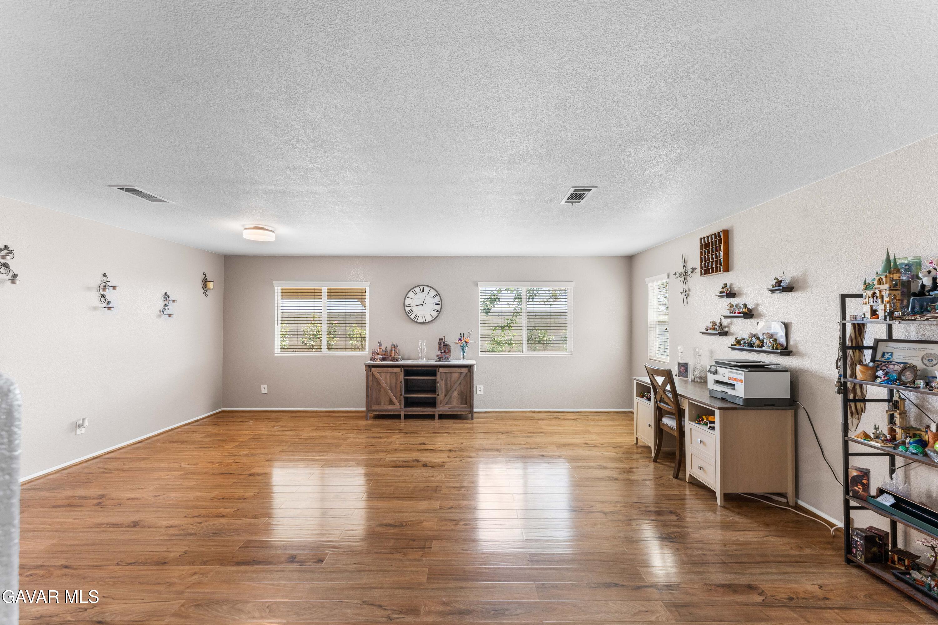45448 Spahn Lane Lancaster, CA 93535 - Photo 15 of 49 a view of an empty room with window and wooden floor