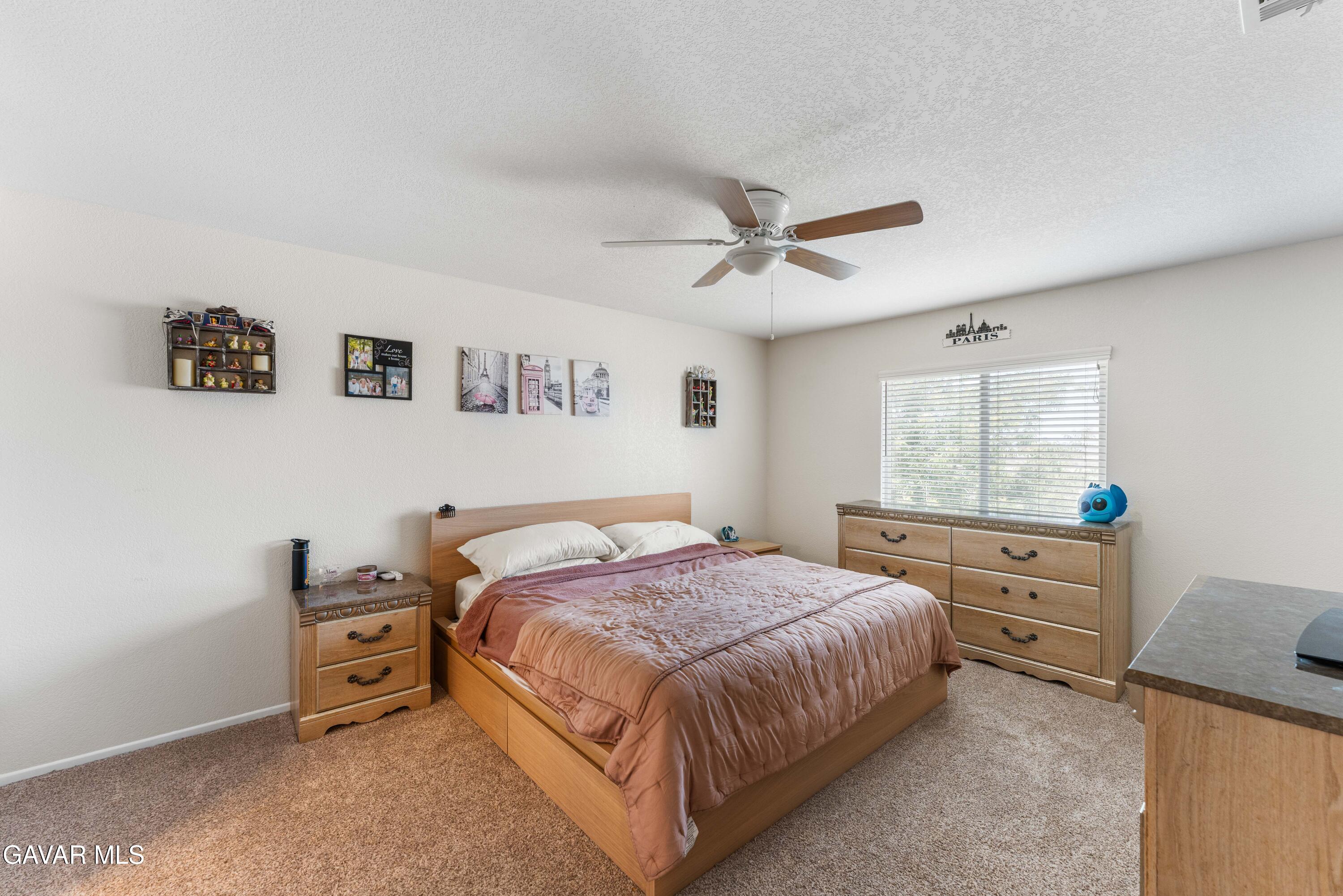 45448 Spahn Lane Lancaster, CA 93535 - Photo 24 of 49 a bedroom with a bed and a window