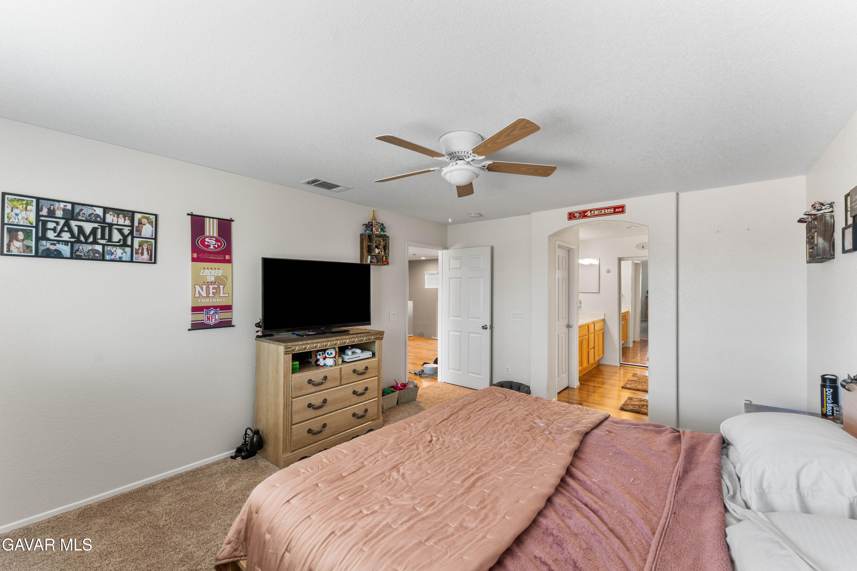 45448 Spahn Lane Lancaster, CA 93535 - Photo 25 of 49 a bedroom with a bed and a flat screen tv