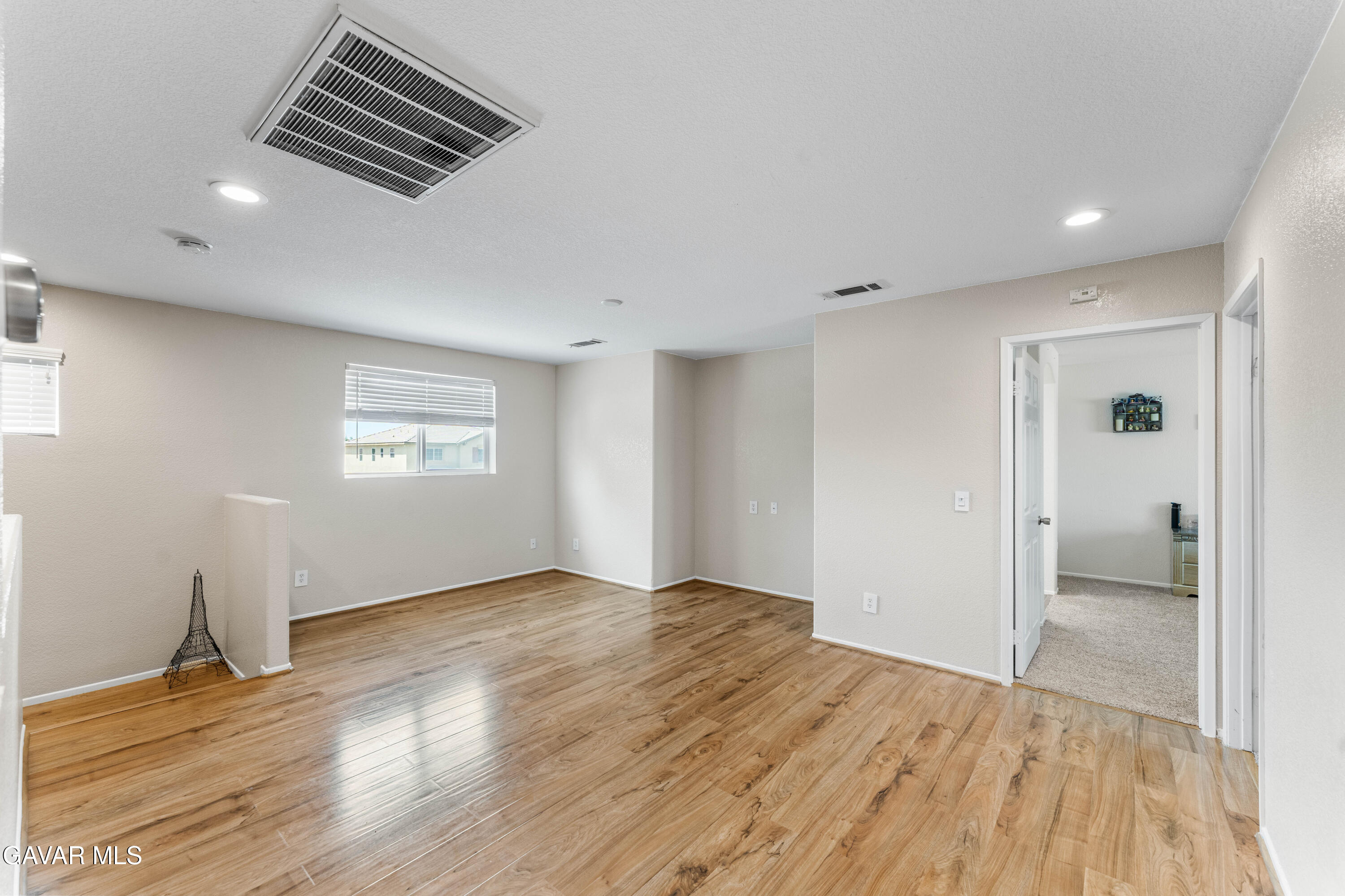 45448 Spahn Lane Lancaster, CA 93535 - Photo 31 of 49 a view of an empty room with wooden floor and a window