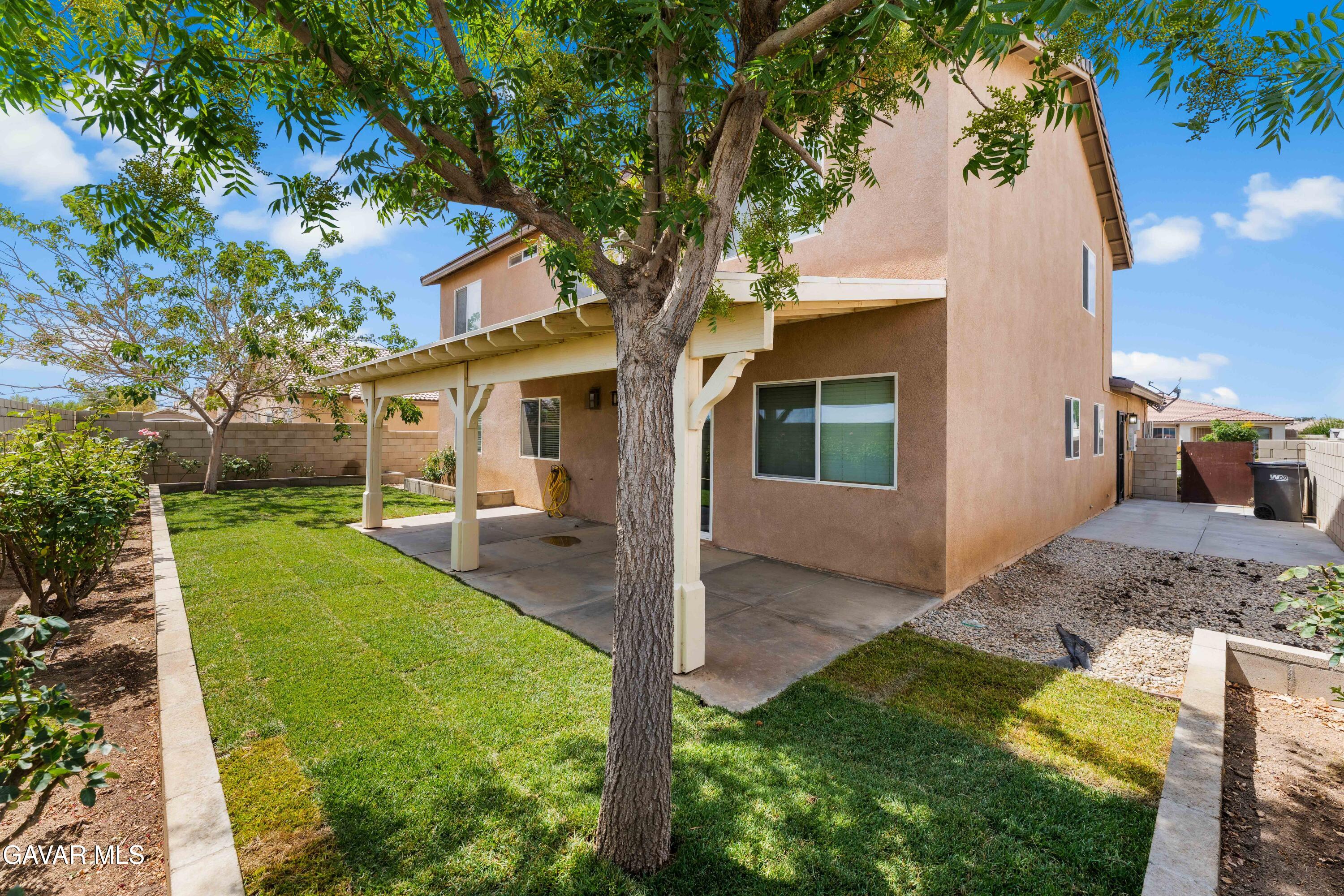 45448 Spahn Lane Lancaster, CA 93535 - Photo 35 of 49 a view of a house with backyard and a tree
