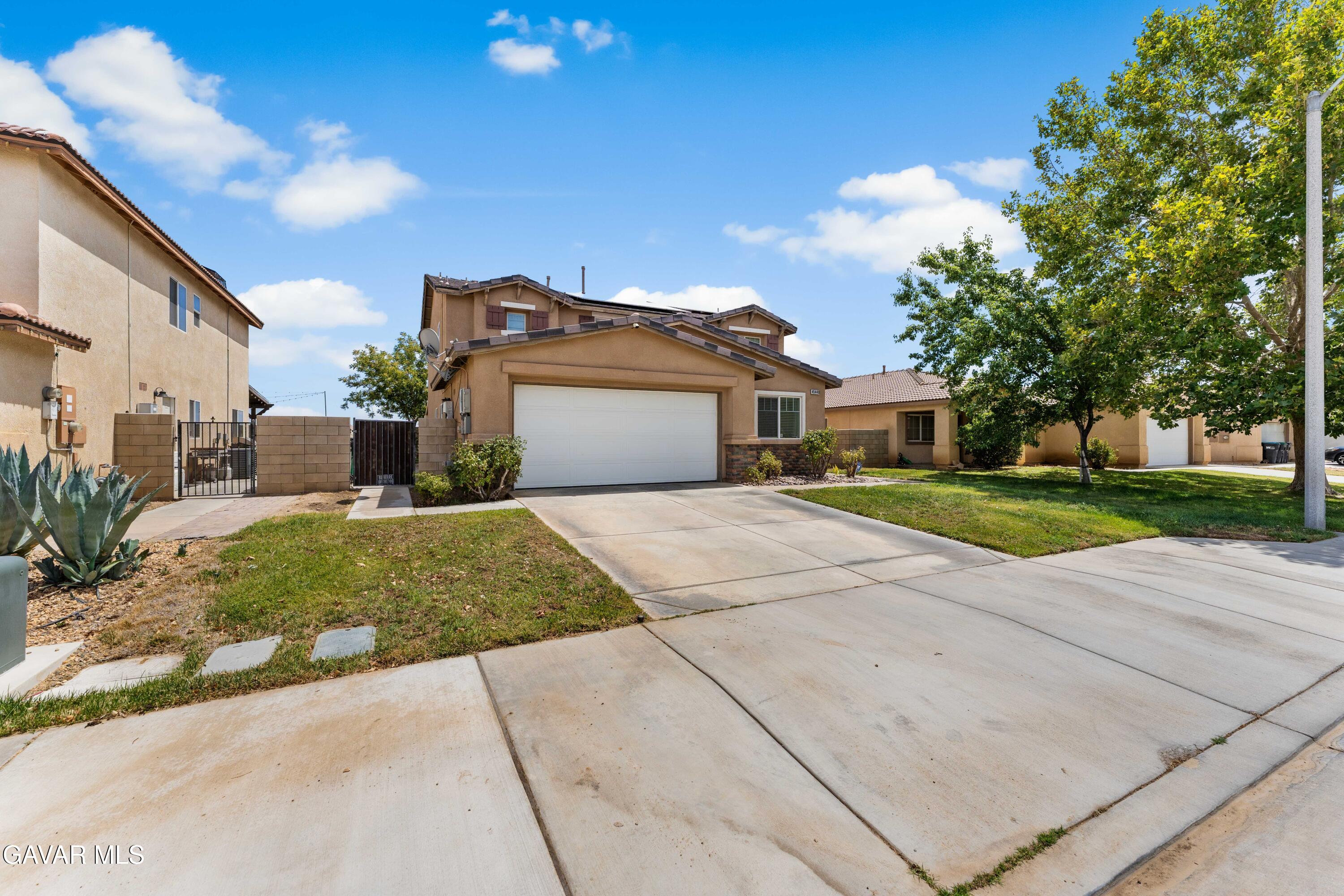 45448 Spahn Lane Lancaster, CA 93535 - Photo 38 of 49 a front view of a house with a yard and potted plants