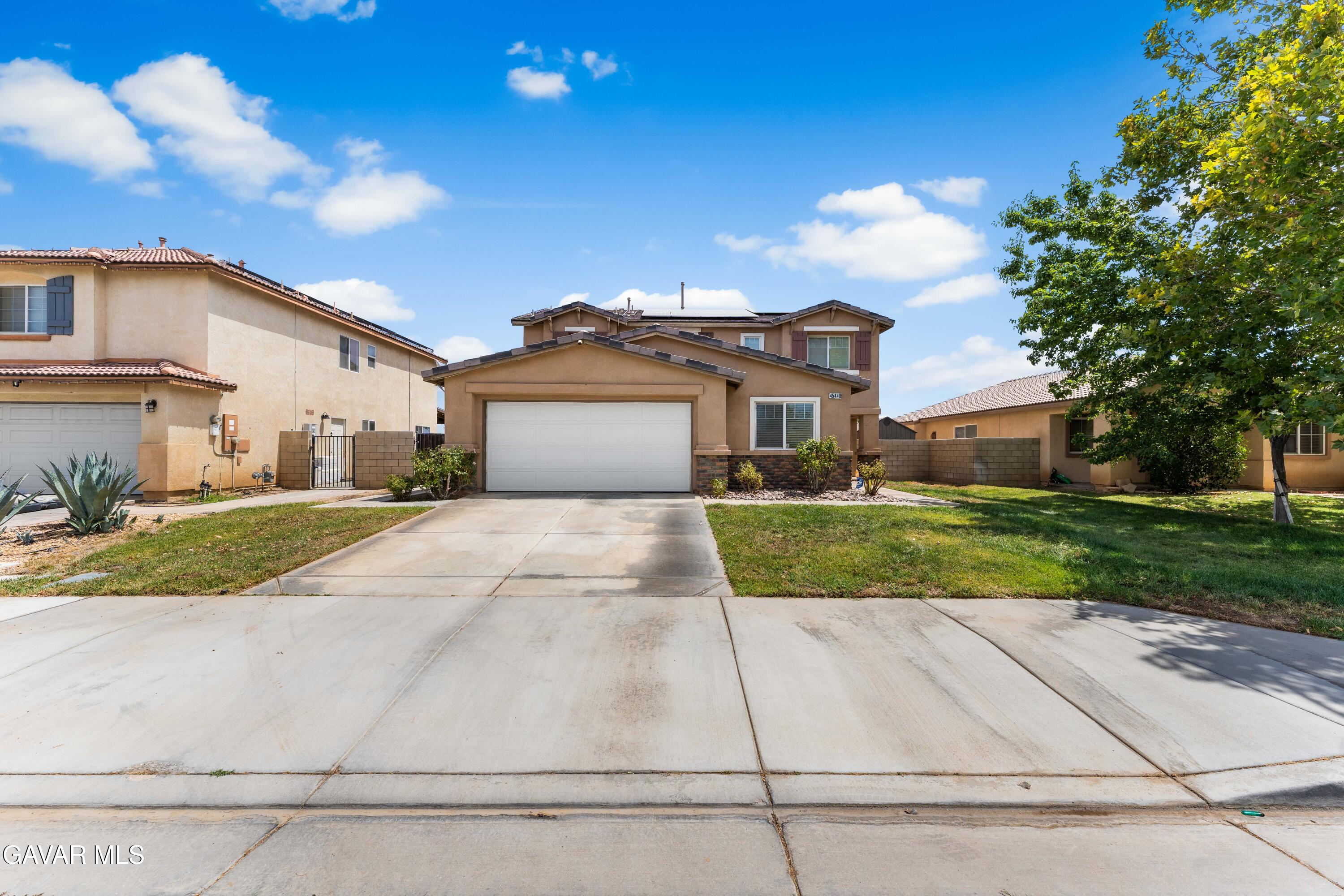 45448 Spahn Lane Lancaster, CA 93535 - Photo 39 of 49 a front view of a house with a yard and garage