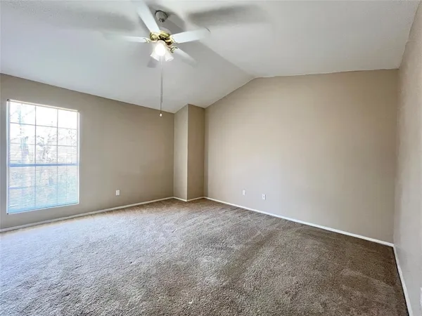 a view of a room with a chandelier fan and windows