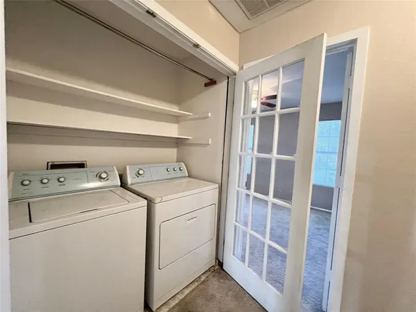 an empty room with windows and ceiling fan