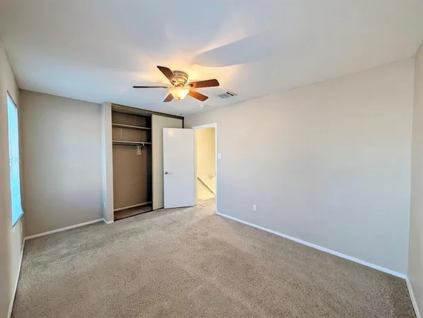an empty room with a view of a house