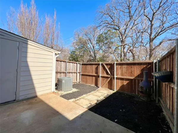 a view of balcony with wooden floor and fence and a bench