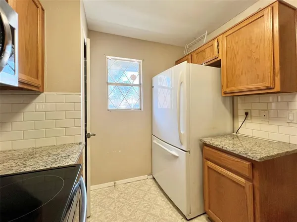 a white refrigerator freezer sitting inside of a kitchen