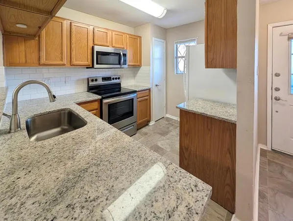 a kitchen with a sink and a stove top oven