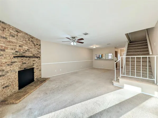 a view of an empty room with a fireplace