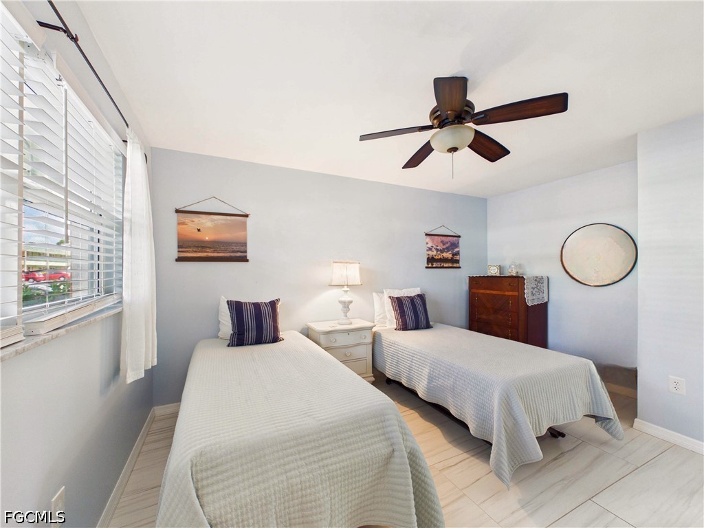 300 Valley Stream Drive, Unit 3D Naples, FL 34113 - Photo 14 of 21 a bedroom with two beds and ceiling fan