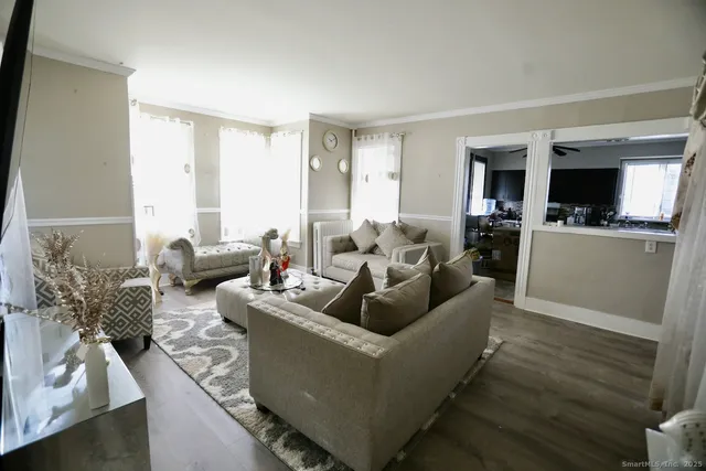 a living room with furniture and a flat screen tv