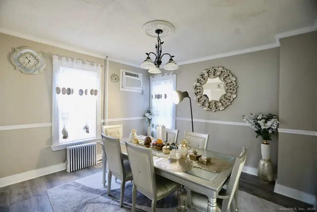 a dining room with furniture and window