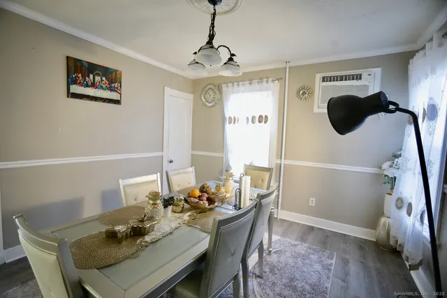 a view of a dining room with furniture and wooden floor