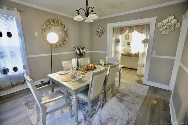 a view of a dining room with furniture window and wooden floor