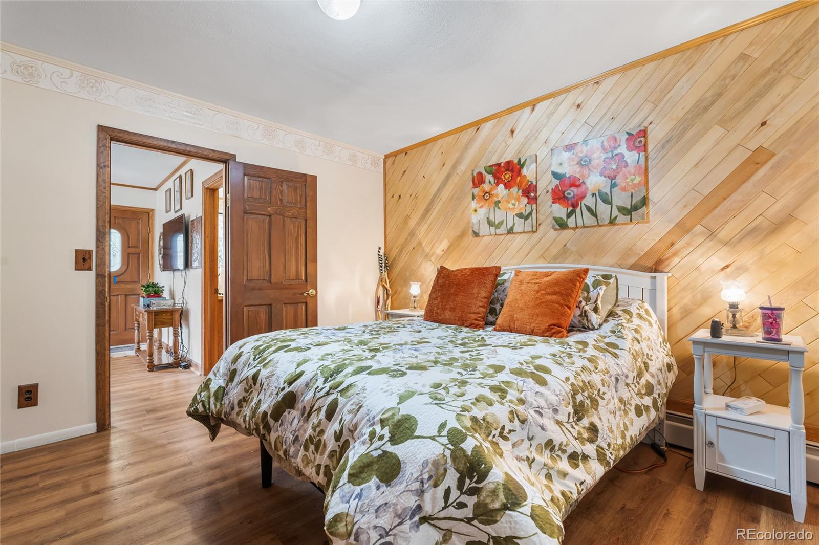 11948 Apache Trail Conifer, CO 80433 - Photo 11 of 45 a bedroom with a bed and a painting on the wall