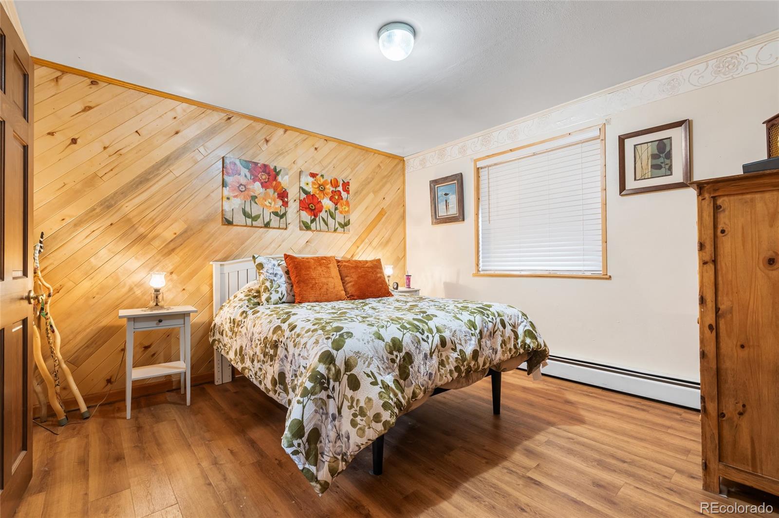 11948 Apache Trail Conifer, CO 80433 - Photo 12 of 45 a bedroom with a bed and wooden floor