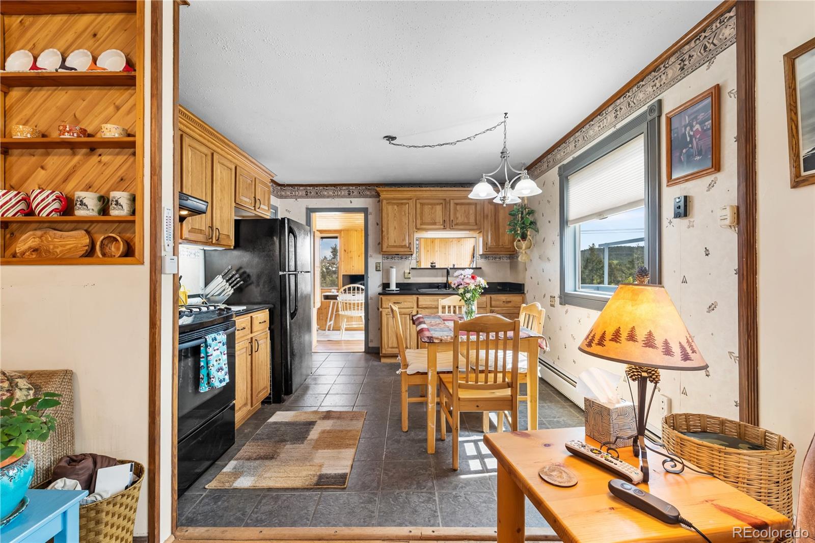 11948 Apache Trail Conifer, CO 80433 - Photo 15 of 45 a living room with fireplace furniture and a large window