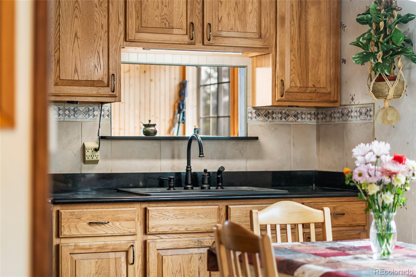 11948 Apache Trail Conifer, CO 80433 - Photo 17 of 45 a kitchen with a window a sink and cabinets