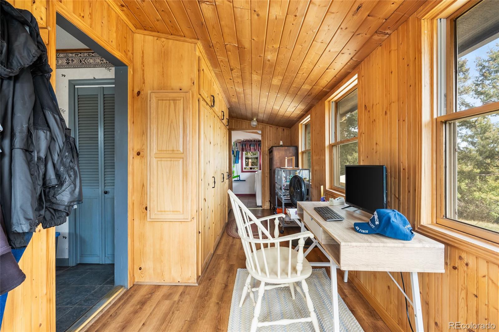 11948 Apache Trail Conifer, CO 80433 - Photo 21 of 45 a view of a dining room with furniture a chandelier and wooden floor