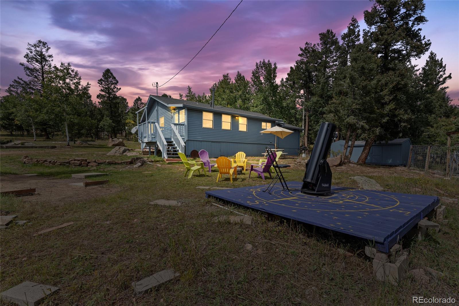 11948 Apache Trail Conifer, CO 80433 - Photo 30 of 45 a view of a wooden deck in front of a house with a yard