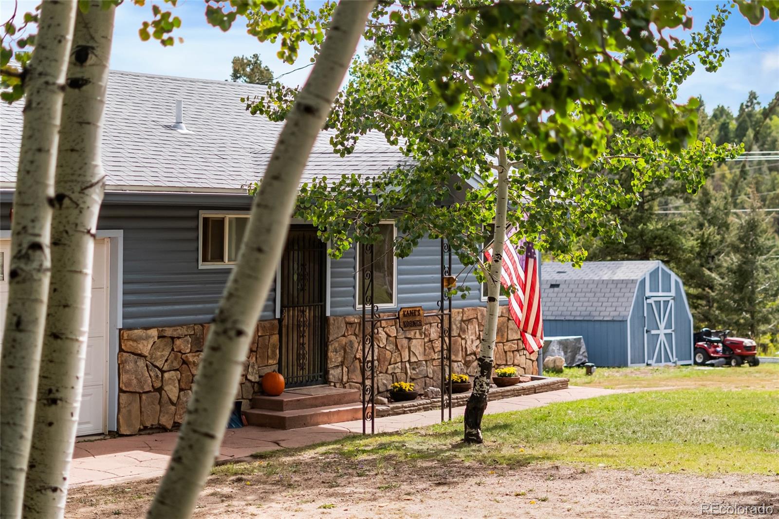 11948 Apache Trail Conifer, CO 80433 - Photo 3 of 45 a front view of a house with garden