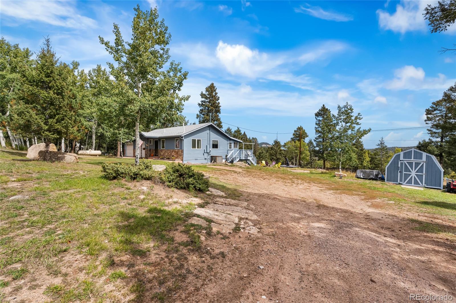 11948 Apache Trail Conifer, CO 80433 - Photo 32 of 45 a front view of a house with a yard
