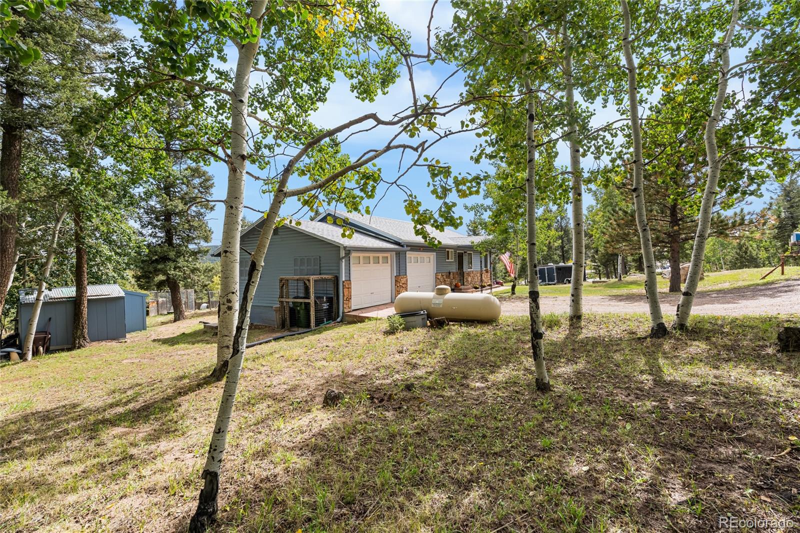 11948 Apache Trail Conifer, CO 80433 - Photo 43 of 45 a view of a house with a backyard and tree