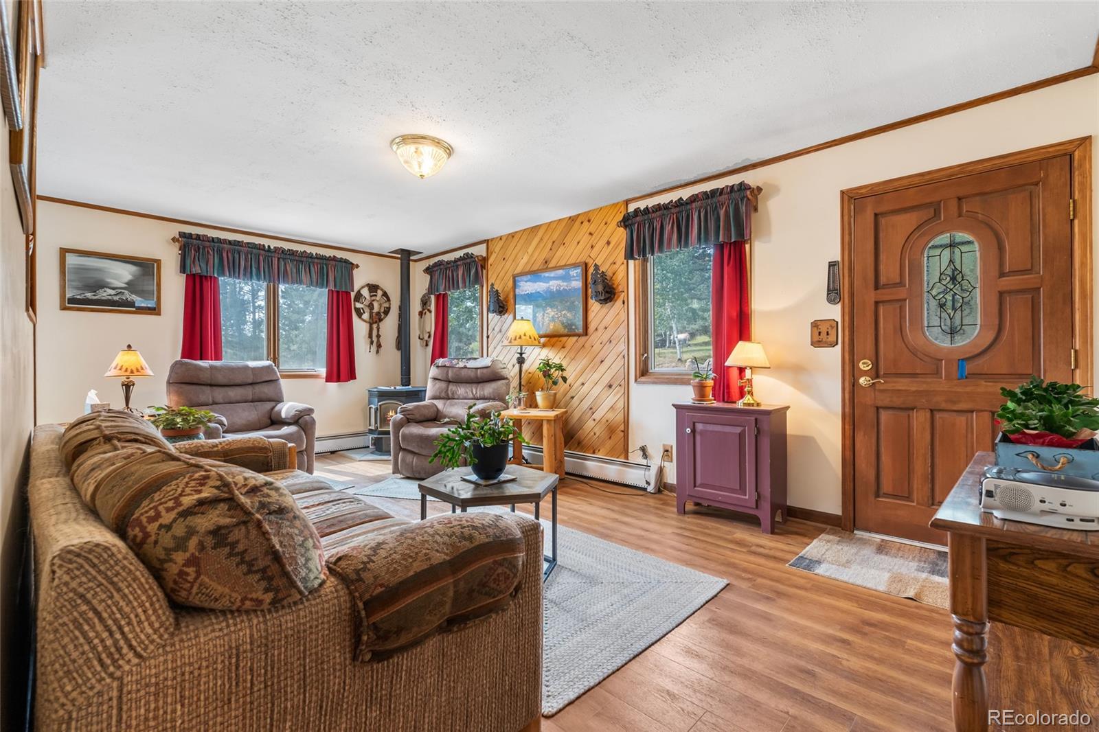 11948 Apache Trail Conifer, CO 80433 - Photo 5 of 45 a living room with furniture a flat screen tv and a floor to ceiling window