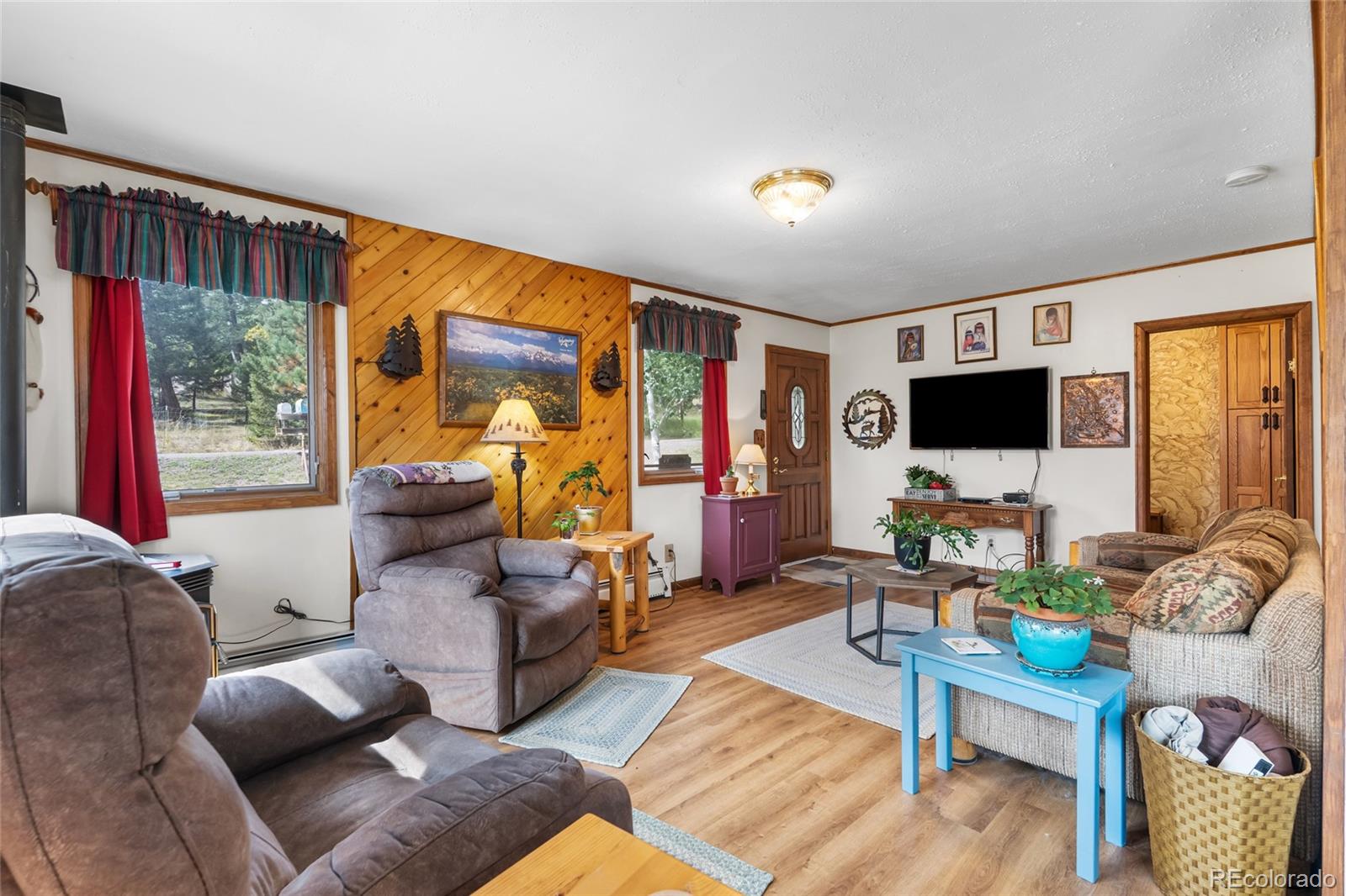 11948 Apache Trail Conifer, CO 80433 - Photo 7 of 45 a living room with furniture and a flat screen tv