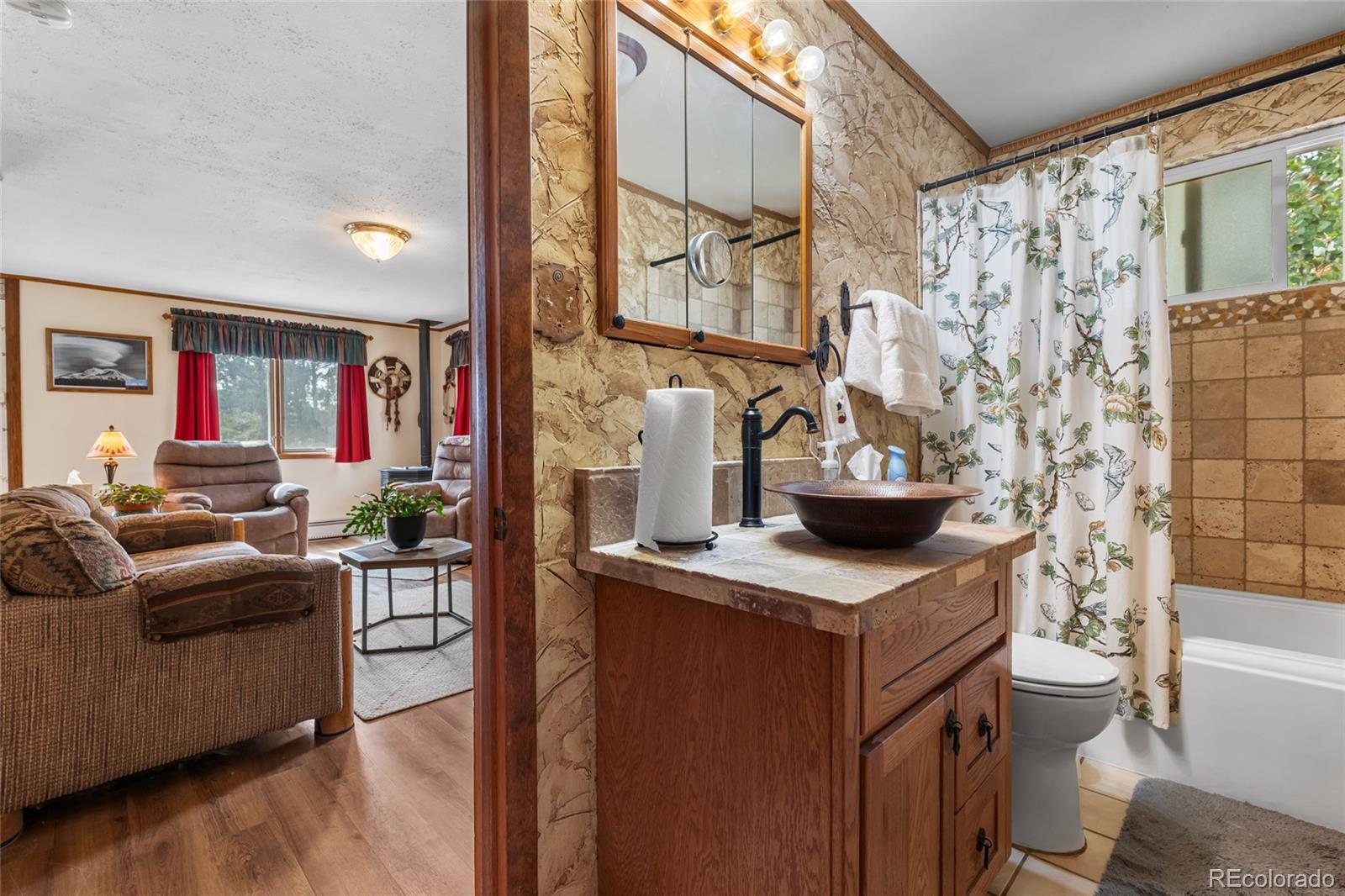 11948 Apache Trail Conifer, CO 80433 - Photo 8 of 45 a living room with stainless steel appliances kitchen island granite countertop furniture a rug and a wooden floor