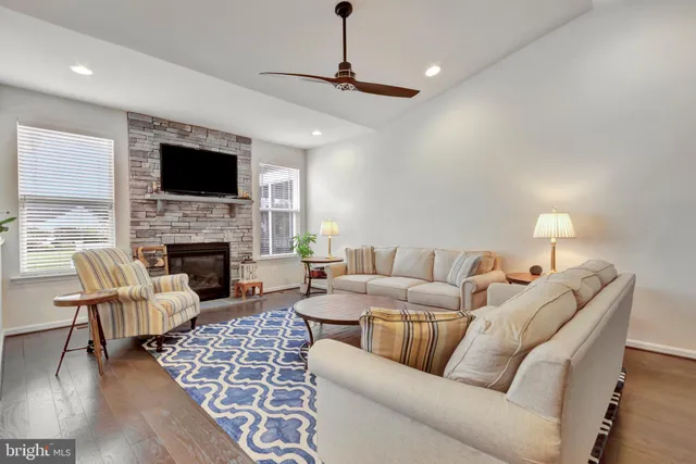 a kitchen with stainless steel appliances granite countertop a white cabinets and a stove top oven