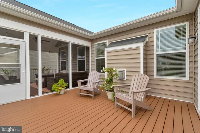 a view of a lake with a yard and large trees