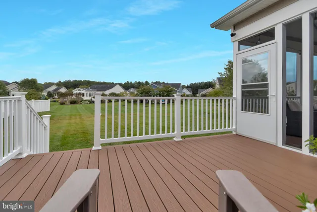 a view of a deck with a floor to ceiling yard next to a yard
