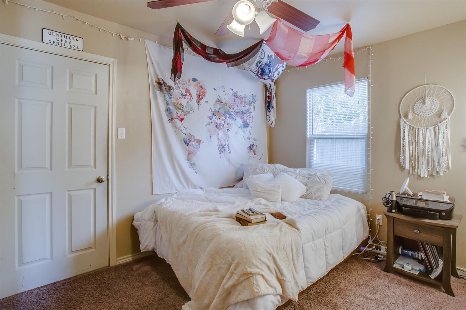 3114 30th Street Lubbock, TX 79410 - Photo 10 of 19 a bedroom with a bed and dresser with mirror