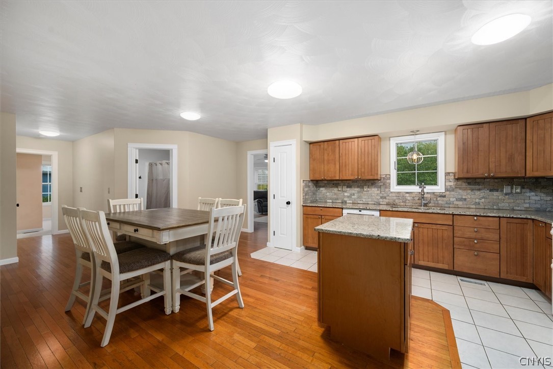 1322 Sawmill Road Sangerfield, NY 13480 - Photo 23 of 50 Gleaming hardwood floors and a central prep island anchor this functional culinary workspace.