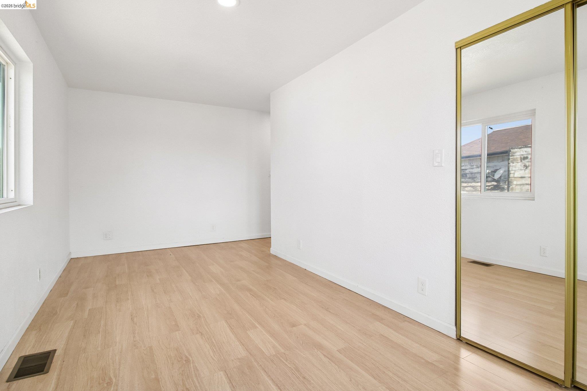 874 Pine Street Oakland, CA 94607 - Photo 15 of 39 Spacious room featuring light wood-finish flooring, white walls, and a recessed ceiling light