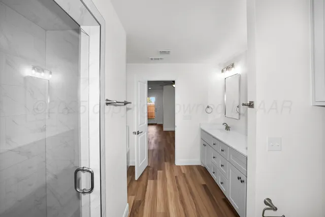 a bathroom with a double vanity sink and mirror