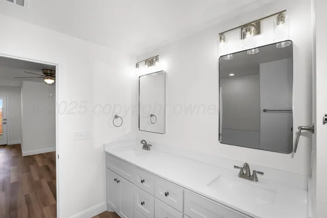 a bathroom with a double vanity sink mirror and double