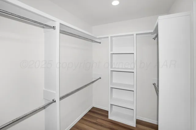 an empty room with a window and a ceiling fan