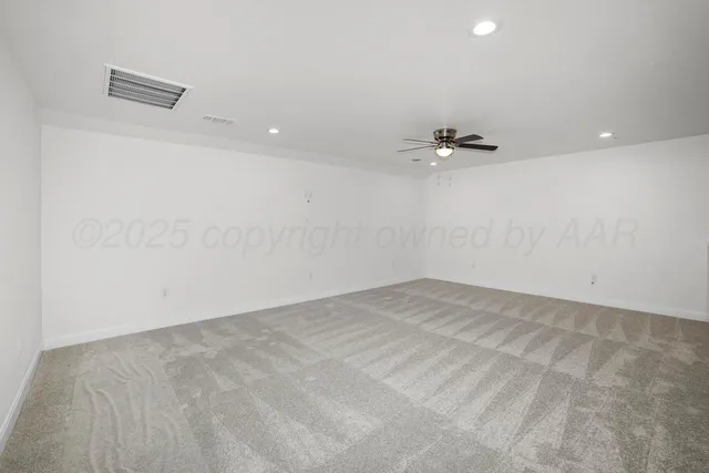 an empty room with a ceiling fan and a ceiling fan