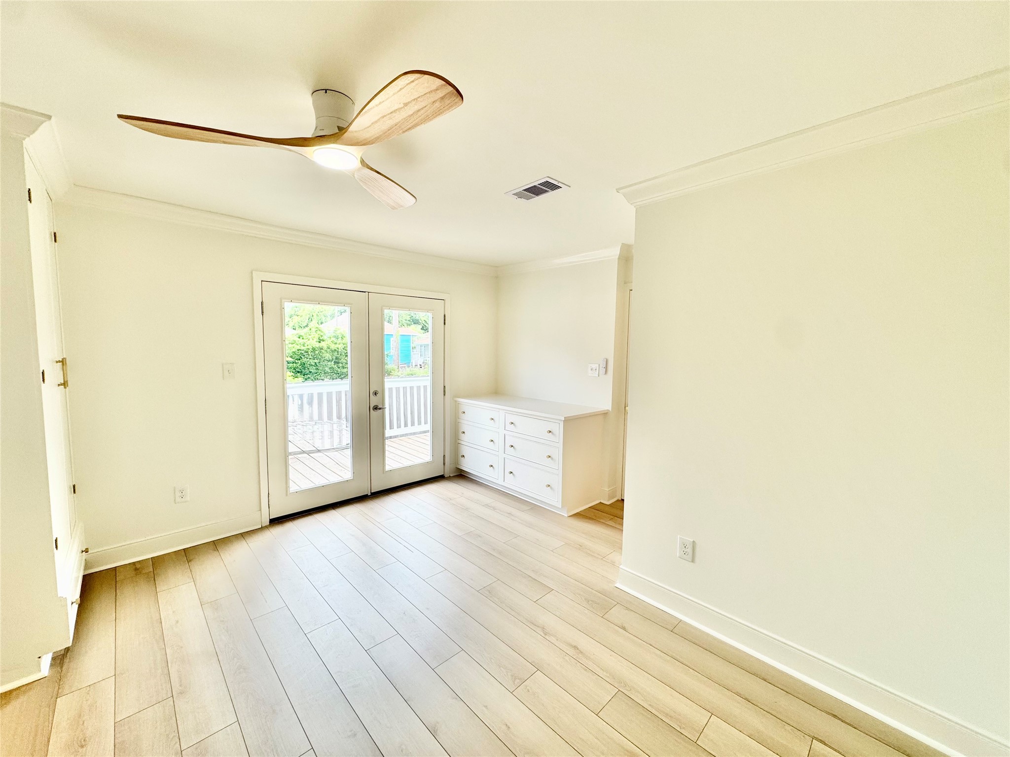 1312 35th Street Galveston, TX 77550 - Photo 19 of 32 a view of an empty room with wooden floor and a window