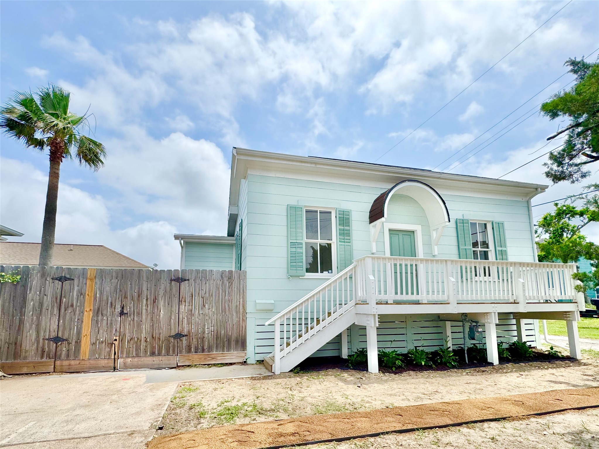 1312 35th Street Galveston, TX 77550 - Photo 2 of 32 a front view of a house with a garden