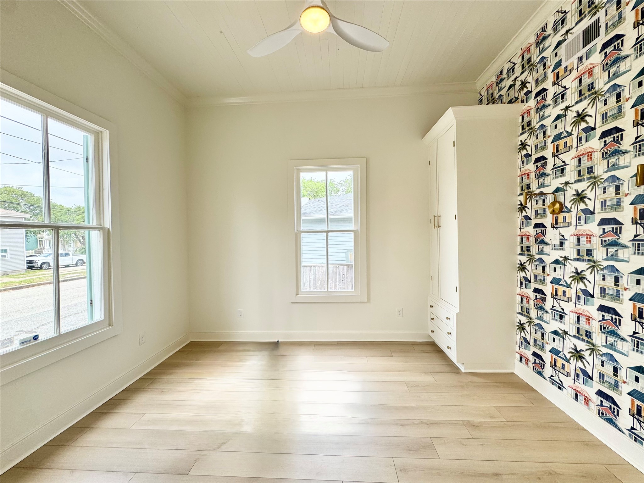 1312 35th Street Galveston, TX 77550 - Photo 25 of 32 a view of an empty room with a window and wooden floor