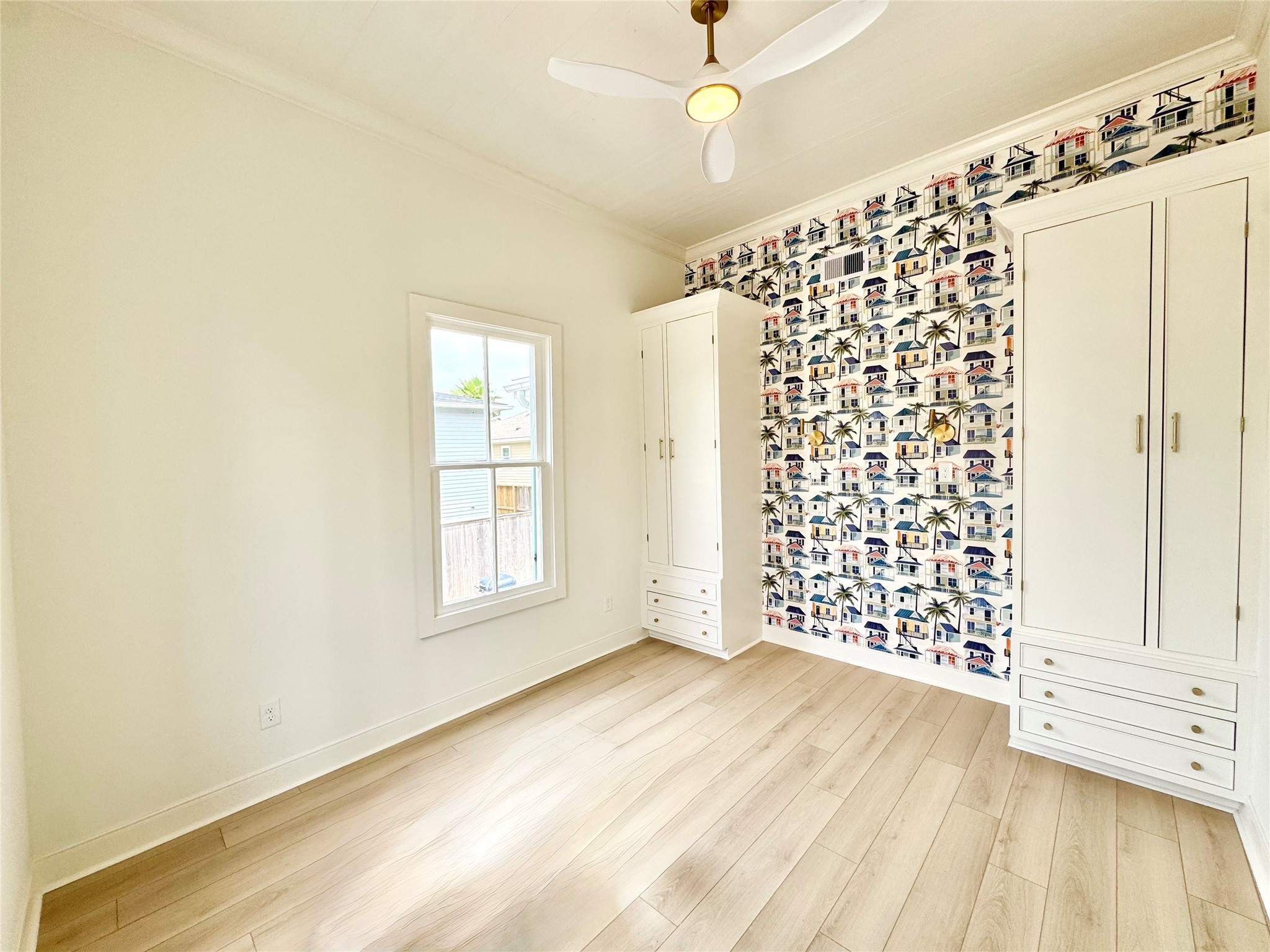 1312 35th Street Galveston, TX 77550 - Photo 26 of 32 a view of an empty room with a window and wooden floor