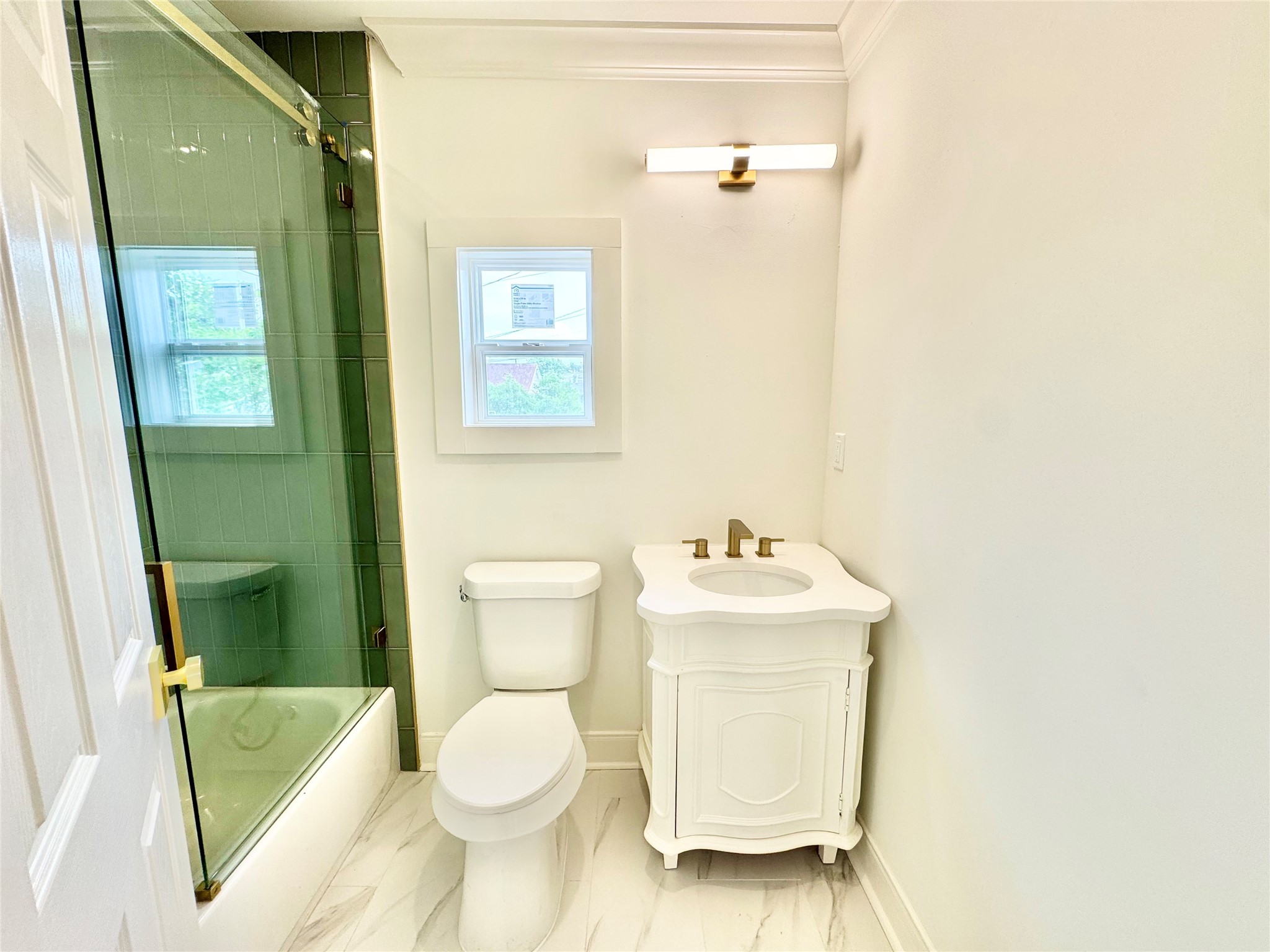 1312 35th Street Galveston, TX 77550 - Photo 28 of 32 a bathroom with a toilet sink and mirror